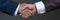 Man in suit shake hand as hello in office closeup