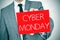 Man in suit with a signboard with the text cyber monday