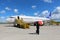 Man in suit standing beside an airliner