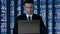 Man in suit texting on laptop against numerical data changing background