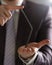 Man in suit and tie bend nail with arms closeup