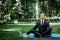 Man in a suit with tie. Business man relaxing in a park in the lotus position, he can`t relax in any way