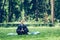 Man in a suit with tie. Business man relaxing in a park in the lotus position, he can`t relax in any way