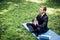 Man in a suit with tie. Business man relaxing in a park in the lotus position, he can`t relax in any way