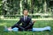 Man in a suit with tie. Business man relaxing in a park in the lotus position, he can`t relax in any way