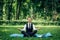 Man in a suit with tie. Business man relaxing in a park in the lotus position, he can`t relax in any way, meditation