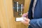 Man in suit using blank screen mobile phone inside of the elevator in business office building