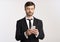 Man In Suit Using Phone Texting With Colleagues, White Background