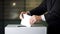 Man in a suit voting, putting paper in a ballot box, concept of politics and elections.