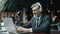 Man in suit working with laptop and enjoying music in headphones in cafe