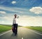 Man with suitcase walking on the road