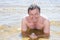 Man in summer vaction lying on sand water holidays