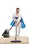 Man in a superhero costume vacuuming a carpet