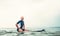 Man surfer sits on surf board in the water and waits waves