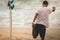 Man surfer stretching and warming up before surfing