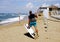 Man surfers in wetsuits with kite equipment for surfing, in Sabaudia, Lazio, Italy