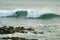 Man surfing on the breaking waves in Pacific Ocean at Hanga Roa, Easter Island, Chile, South America