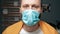 Man in surgical mask. Masked attractive guy looks at camera. Cold, flu, virus, tonsillitis, acute respiratory disease,