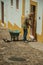 Man sweeping the front of house in street of Evoramonte