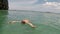 Man swimming on back in sea action camera pov of young guy lying on water on beautiful beach