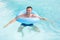 Man swimming in pool with blue buoy