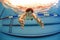 Man in swimming pool streching hands