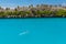 Man swimming with snorkel and paddles in crystalline water of tu