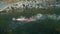 A man swims breaststroke in the river against the current