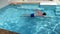 The man swims under water in the pool
