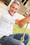 Man swinging at a playground, portrait