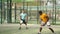 Man in t-shirt playing padel tennis on court. Racket sport training outdoors.