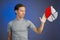 Man in t-shirt working with pie chart on blue background.