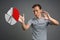 Man in t-shirt working with pie chart on grey background.