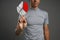 Man in t-shirt working with pie chart on grey background.