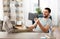 Man with tablet pc resting feet on table at home