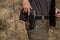 Man in tactical clothes shooting from a pistol, reloading the gun and aiming at the target in the open-door Shooting range.