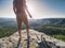 Man take break for snack while climbing in rocks. Hiker in shorts