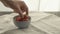 man take fresh strawberries from blue bowl on linen napkin