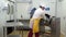 Man takes apart equipment for mixing salads with industrial washing equipment.