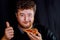 Man in takes an appetizing hands take a delicious piece of pizza