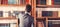 Man takes book from bookcase. Student stands in library and choose book. Guy in smart suit reads near bookcase. Study