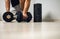 man takes a break during dumbbell training at home. fitness training concept, motivation.new year\'s resolutions