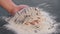 Man takes fish in flour from the table in his hand. Cooking fish. Hands close up.