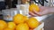 A man takes an orange from the cafe counter and throws it into the air.