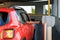 A man takes a parking ticket at the entrance to a paid parking lot by car.