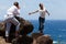 Man Takes Photo of Happy Woman on Hawaiian Cliffs