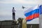 A man takes photos of airplane. Russian state flag tricolor.