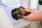 man takes spud from vegetable container. box storing potato, onion, carrot. Container with ventilation, without light