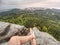 Man taking a break in nature and looking from summit down