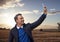 Man taking casual selfie photo in front of farm field landscape